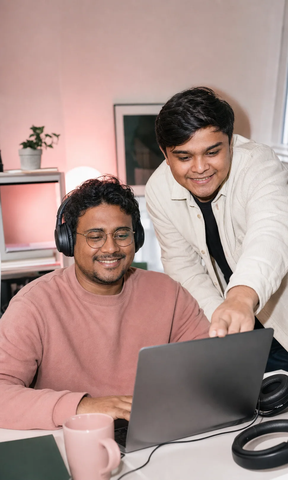 Dos integrantes de Simplixity colaboran frente a una laptop en el estudio